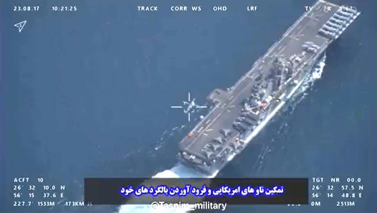 A screengrab from one of the video clips Iran released showing a U.S. helicopter appearing to land aboard the USS <em>Bataan</em> as it transited the Strait of Hormuz on August 17, 2023. <em>IRGC capture via Tasnim News Agency</em>