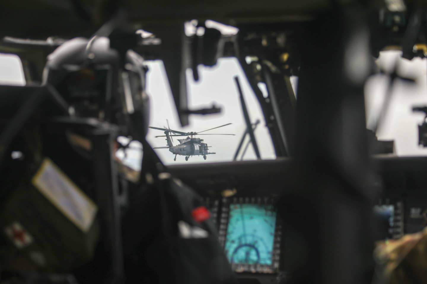An MH-60M helicopter belonging to the US Army's 160th Special Operations Aviation Regiment is seen from the cockpit of another one of the unit's Black Hawks during the Polar Dagger exercise. <em>US Army</em>