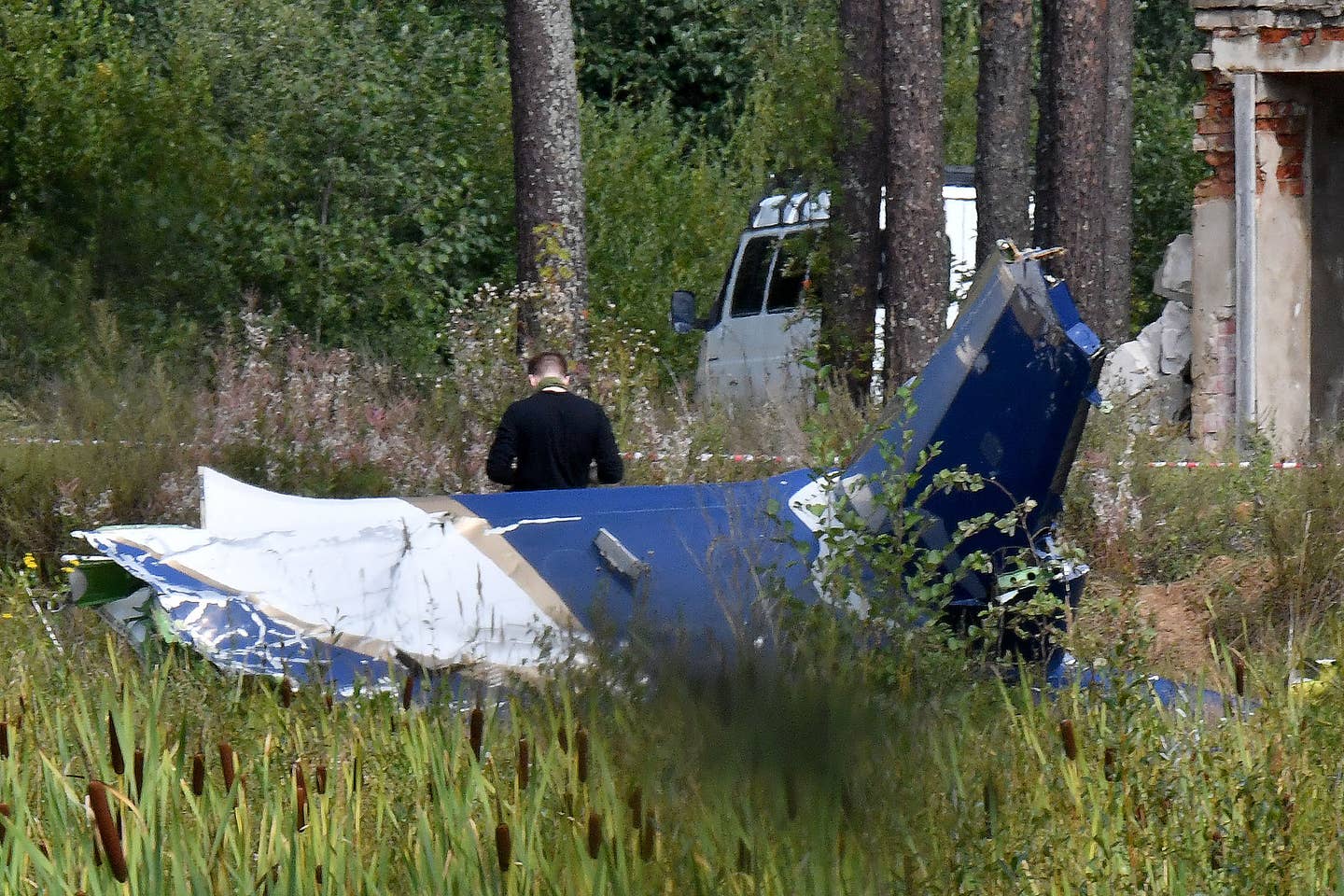A law enforcement officer works at the site of Prigozhin’s plane crash near the village of Kuzhenkino, Tver region, on August 24, 2023. <em>Photo by OLGA MALTSEVA/AFP via Getty Images</em>