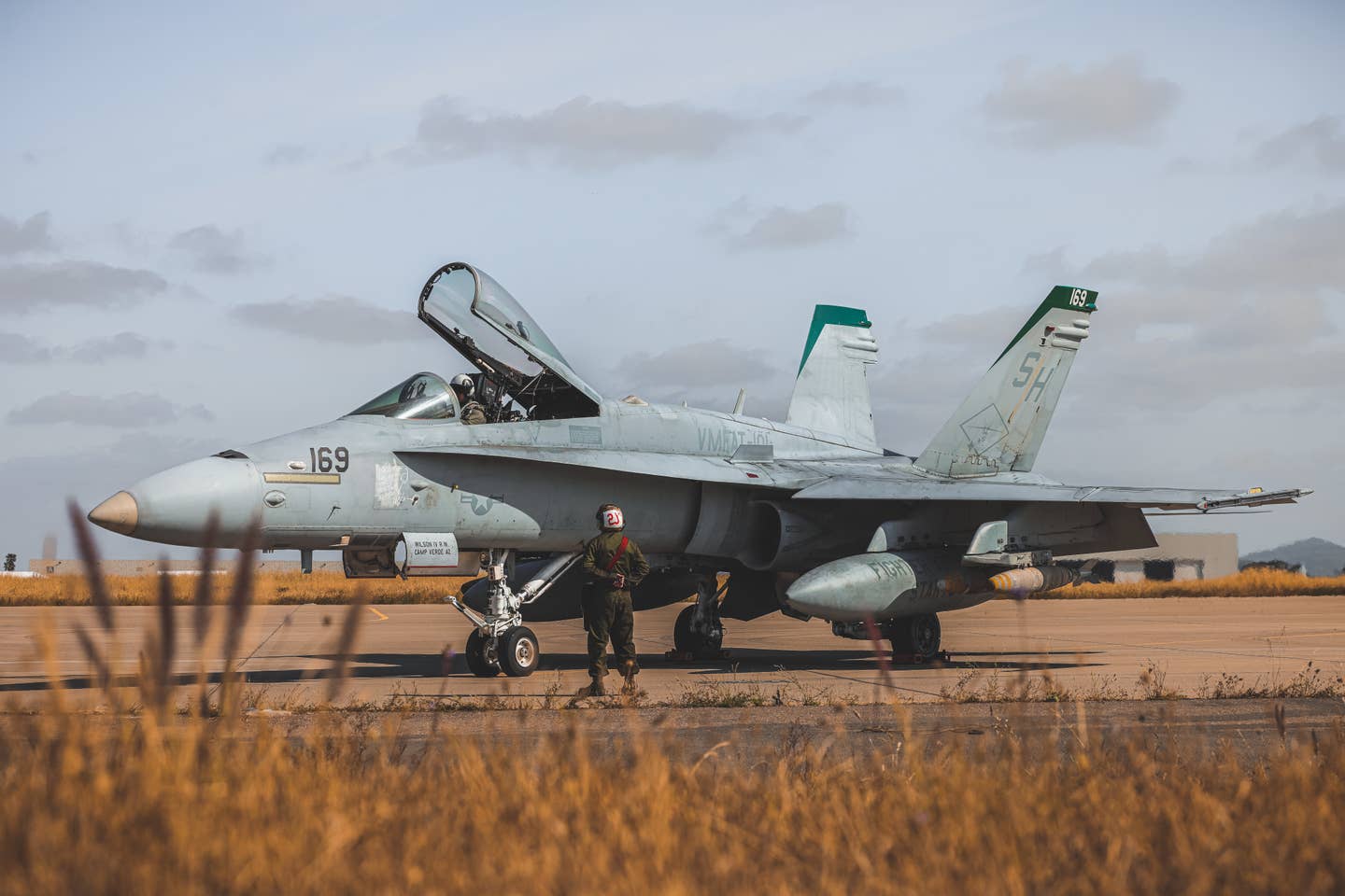 A student pilot with VMFAT-101, MAG-11, 3rd MAW, performs pre-flight checks aboard an F/A- 18C Hornet at Marine Corps Air Station Miramar, California, May 9, 2023. <em>U.S. Marine Corps photo by Lance Cpl. Gadiel Zaragoza</em>