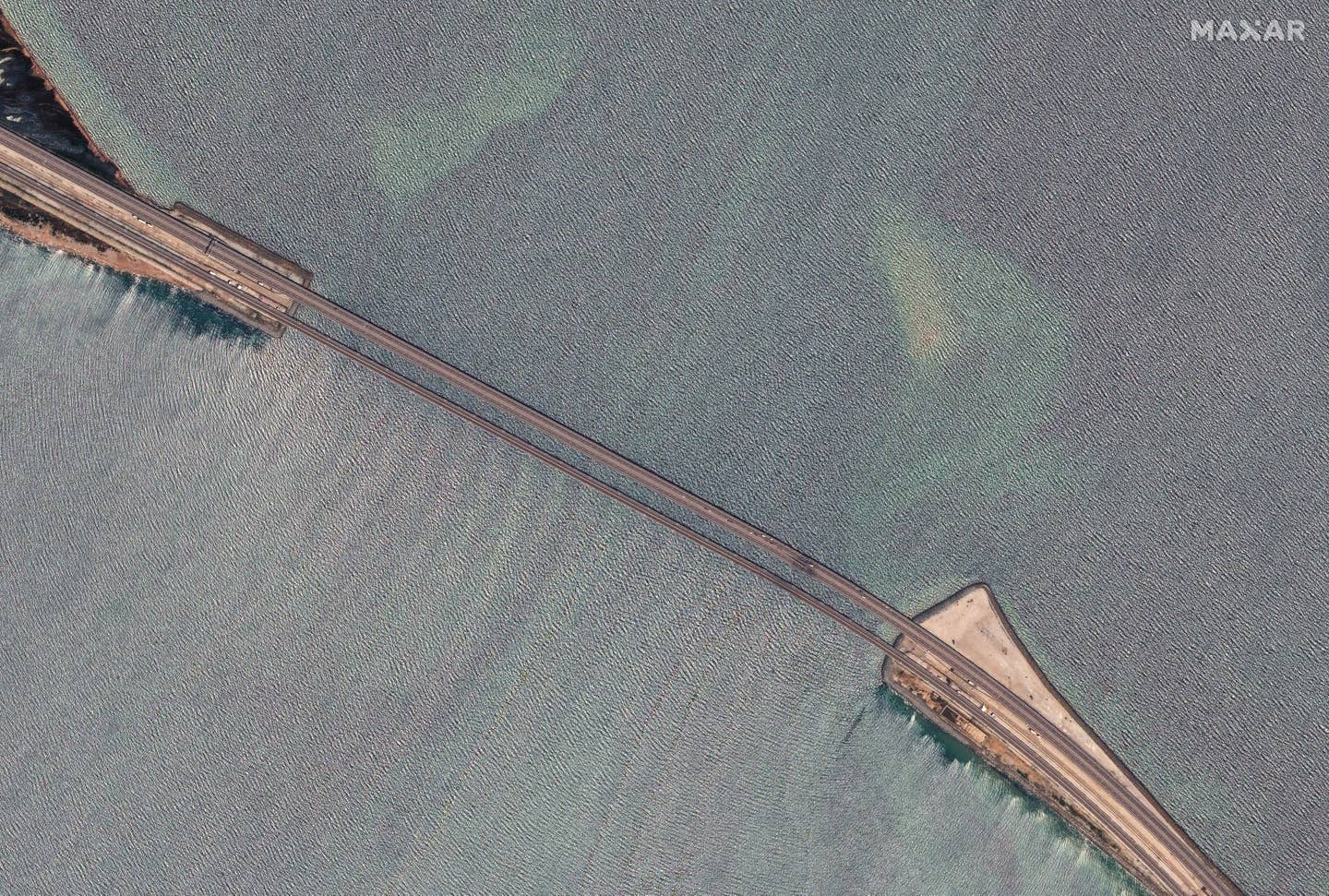 A satellite view of the Kerch Bridge after it was attacked by a Ukrainian uncrewed surface vessel on July 17. (Satellite image ©2023 Maxar Technologies)