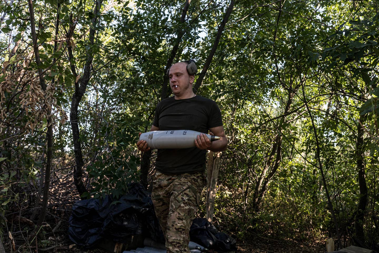 Ukrainian soldier of the Aidar battalion, carries a shell for D-30 artillery on the frontline in the direction of Bakhmut as Russia-Ukraine war continues in Donetsk Oblast, Ukraine on August 14, 2023. (Photo by Diego Herrera Carcedo/Anadolu Agency via Getty Images)