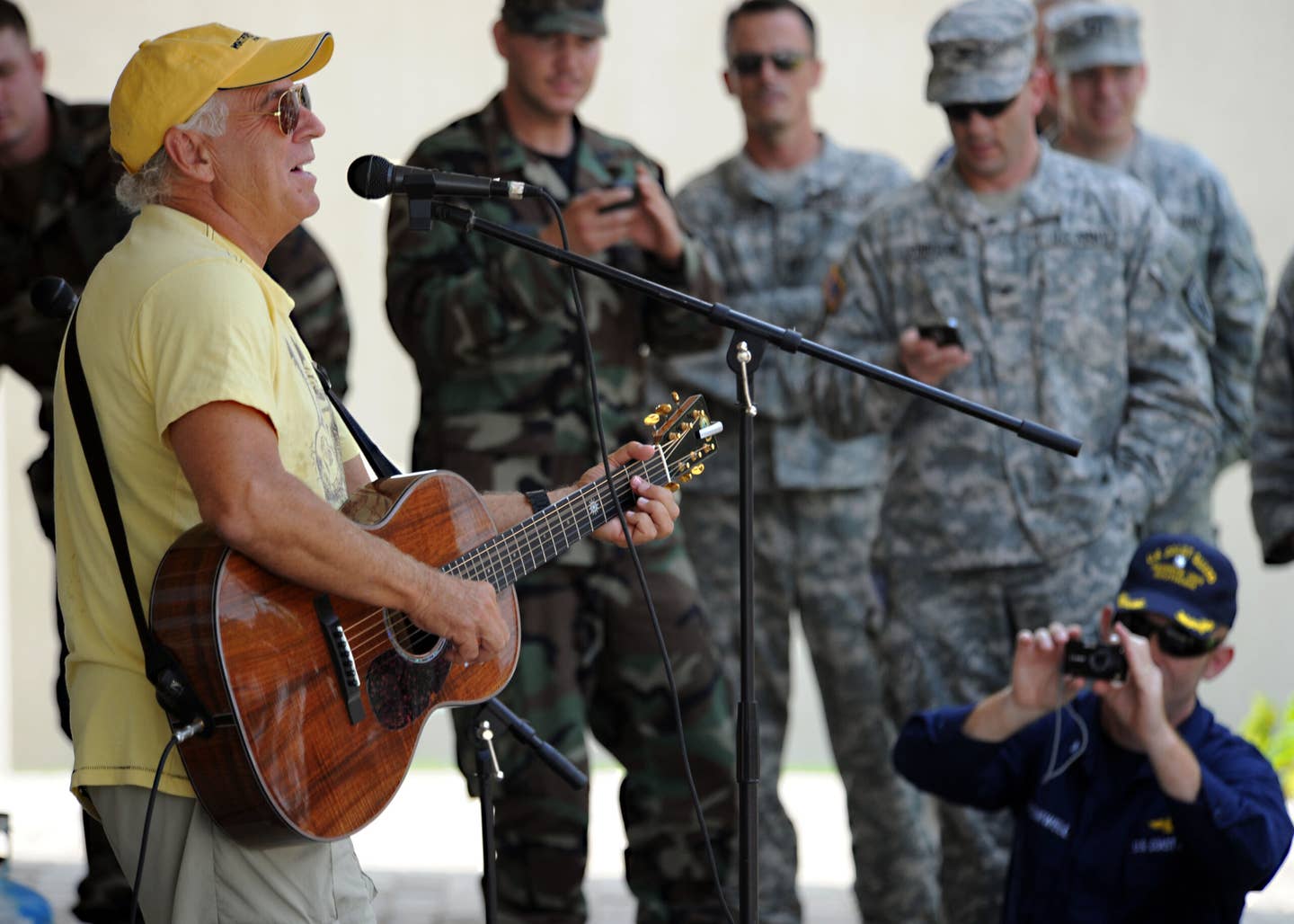 Jimmy Buffet performs for members of Joint Task Force Haiti behind the U.S. Embassy in Port-au-Prince, Haiti, March 3, 2010. <em>U.S. Navy</em>.