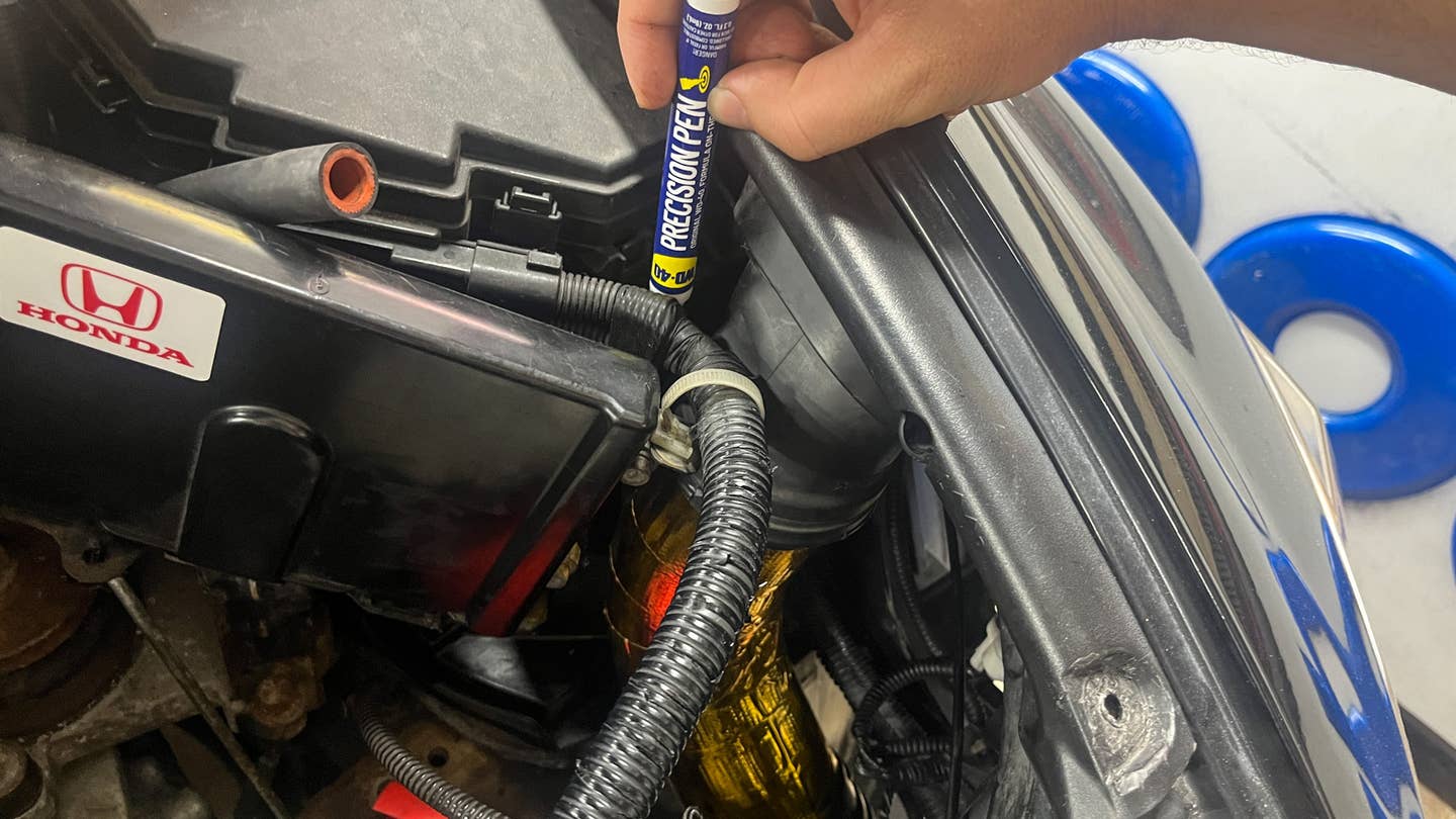 I really didn't want to remove the whole ECU to get this first piece of piping in, but man the mounting nub was so stiff. At the same time, I didn't really want to spray anything near my car's computer brain. Luckily the WD-40 Precision Pen fit right in there quite neatly. <em>Andrew P. Collins</em>