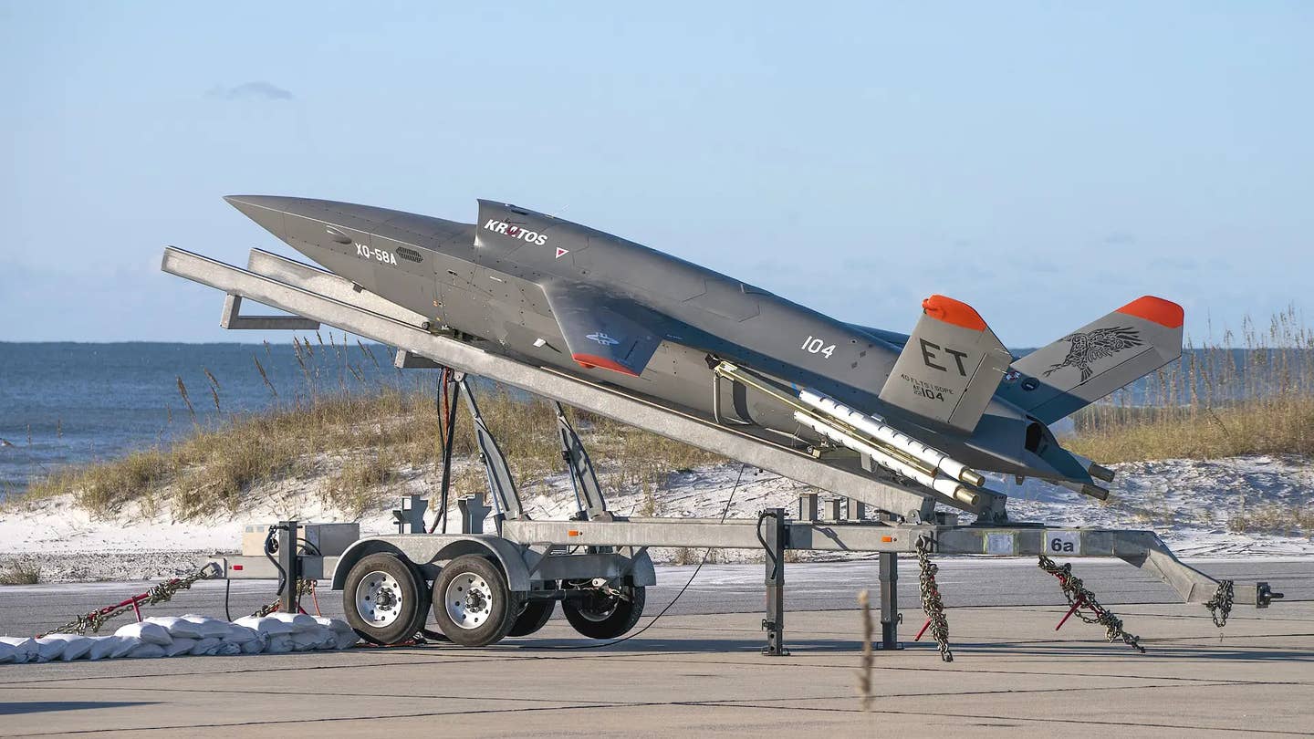 Kratos' XQ-58 Valkyrie uses a trailer-based launcher, as seen here, to get into the air and uses a parachute recovery system at the conclusion of a flight. This all makes it much easier to deploy to the drones even to remote or austere locations. <em>USAF</em>