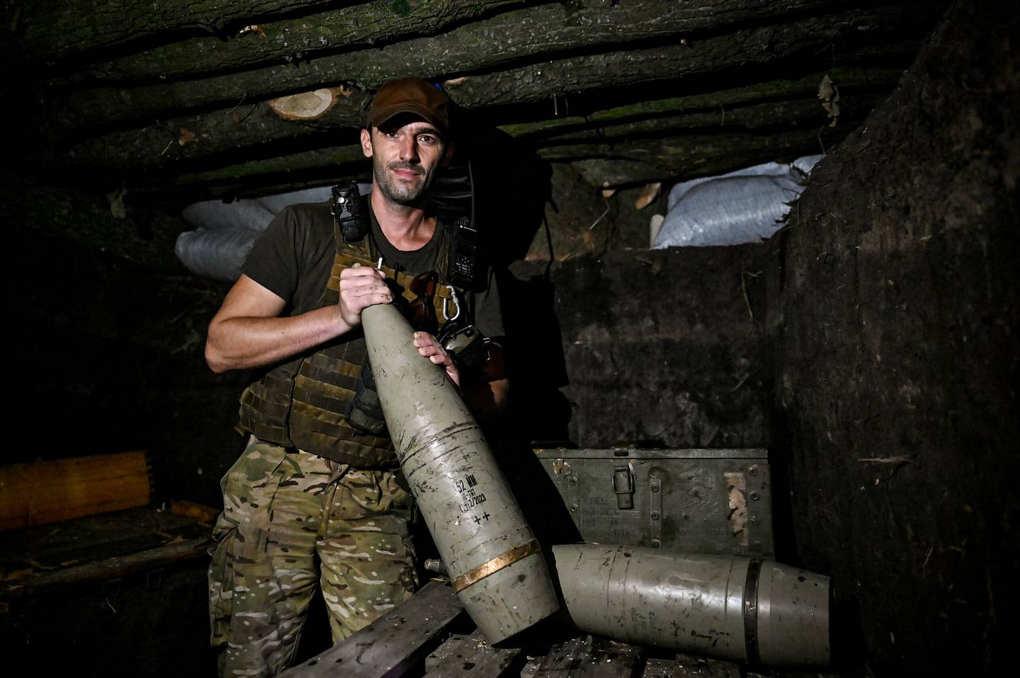 A serviceman poses for a photo with a 152mm shell as the artillery unit of the 128th Mountain Assault Brigade serves in Zaporizhzhia Oblast. (Dmytro Smolienko / Ukrinform/Future Publishing via Getty Images)