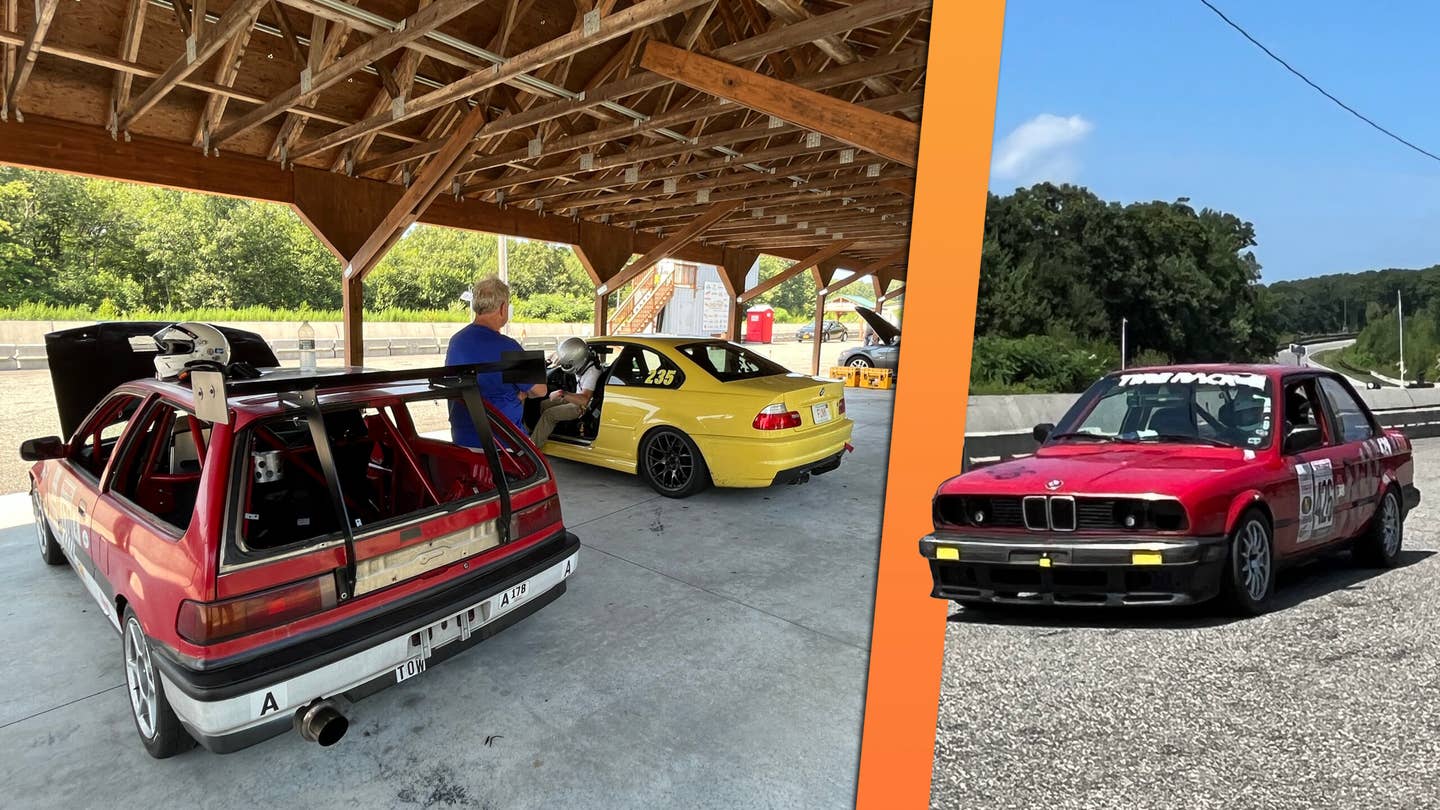 Drivers can rent these shady paved spots for track days to have a nice cool wrenching spot. By pure coincidence, I ran into my friend Chris Perkins, a writer at <em><a href="https://www.roadandtrack.com/author/14987/chris-perkins/" target="_blank" rel="noreferrer noopener nofollow">Road &amp; Track</a></em>, who was also at Palmer with his dad that day! They were lapping that red E30 on the right. <em>Andrew P. Collins</em>