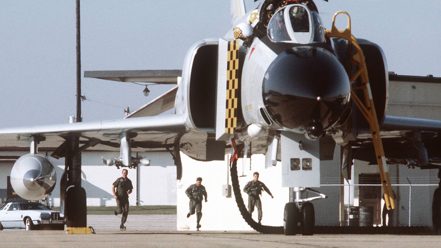 Pilots scramble to their F-4C Phantom II on alert during exercise William Tell '80. USAF