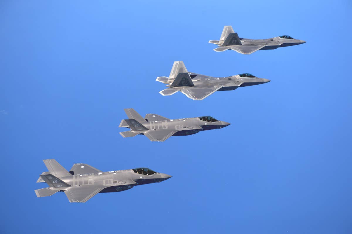 F-35A and F-22 fighters fly together. <em>USAF</em>