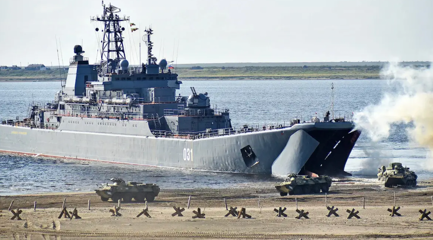 BTR-82 armored personnel carriers disembark from a&nbsp;<em>Ropucha</em>&nbsp;class landing ship during an exercise.&nbsp;<em>DENIS KOZHEVNIKOV/TASS VIA GETTY IMAGES</em>