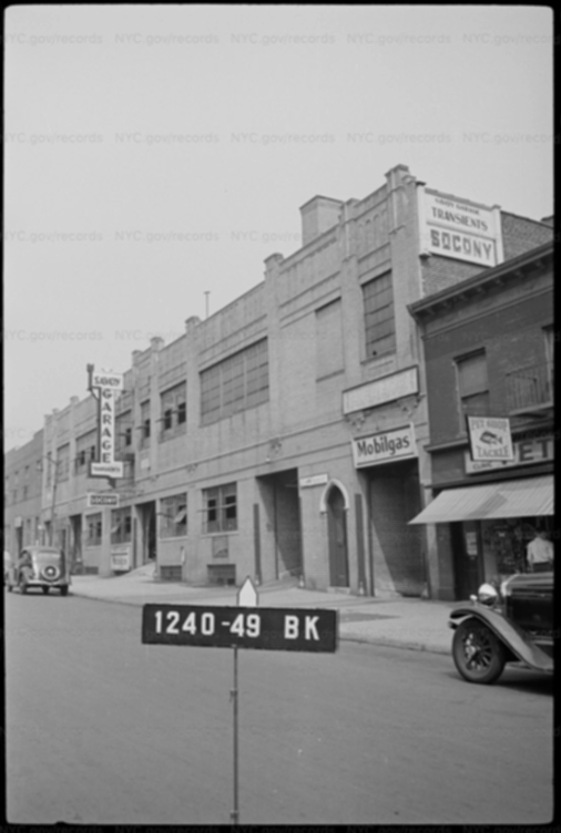 The garage circa 1939. It was then known as Savoy Garage and featured an indoor(!) Mobilgas station. <em>NYC Municipal Archives.</em>