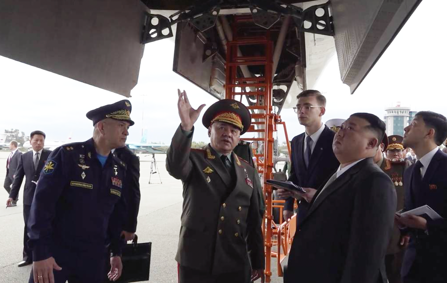 (Left to right): Russia’s Long-Range Aviation Commander Lieutenant General Sergey Kobylash, Russian Minister of Defense Sergey Shoigu, and North Korean leader Kim Jong Un look at a Tu-160 bomber at Knevichi Airfield in Russia’s Far East. <em>Russian Ministry of Defense</em><br>