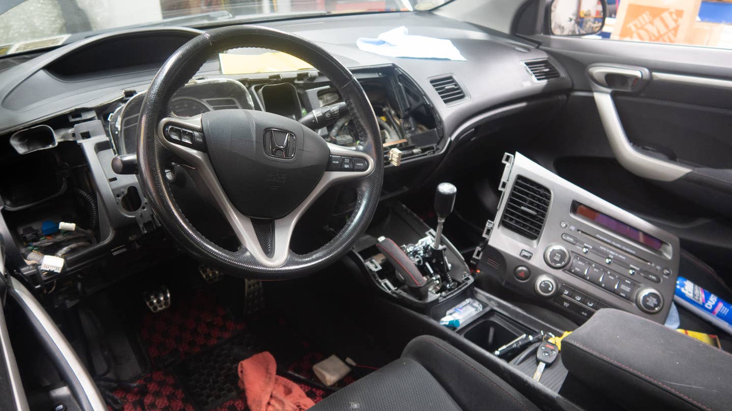 I love how easy this car's interior is to dismantle. Just a few screws and plastic clips hold the whole center console and much of the dashboard in place. <em>Andrew P. Collins</em>