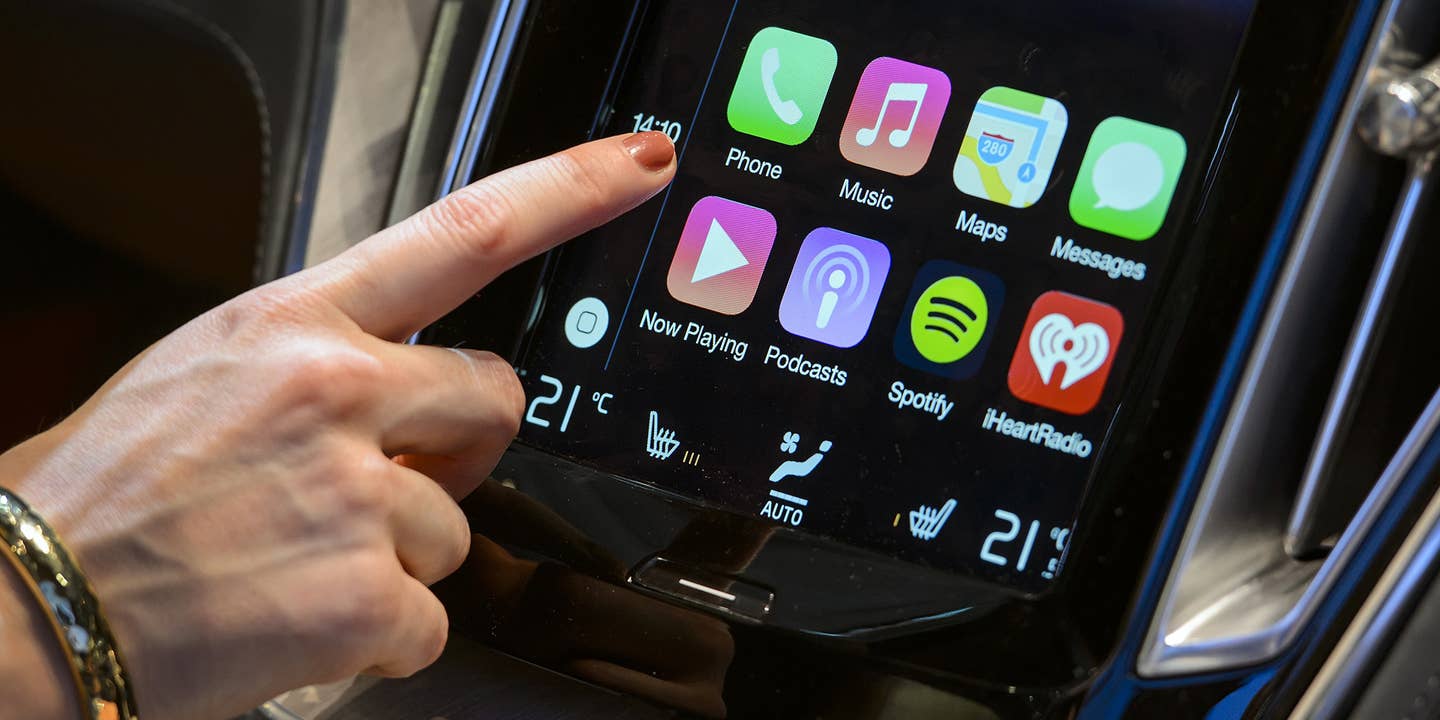 A person uses Apple CarPlay in a Volvo car.