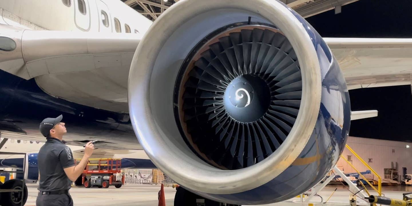 Delta Air Lines technician inspects a jet engine