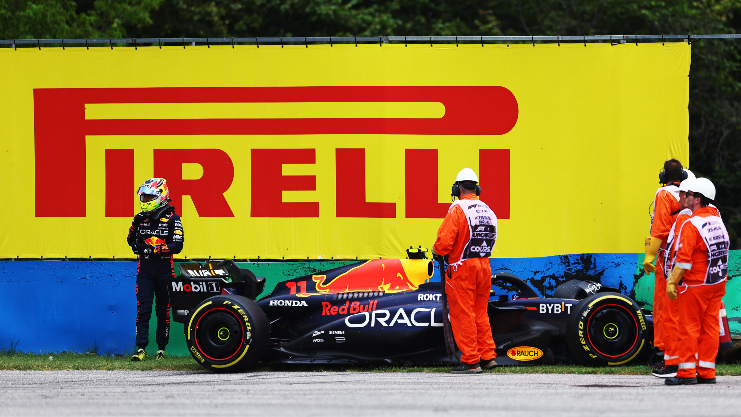 BUDAPEST, HUNGARY - JULY 21: Sergio Perez of Mexico and Oracle Red Bull Racing walks from his car after crashing during practice ahead of the F1 Grand Prix of Hungary at Hungaroring on July 21, 2023 in Budapest, Hungary. (Photo by Bryn Lennon - Formula 1/Formula 1 via Getty Images)