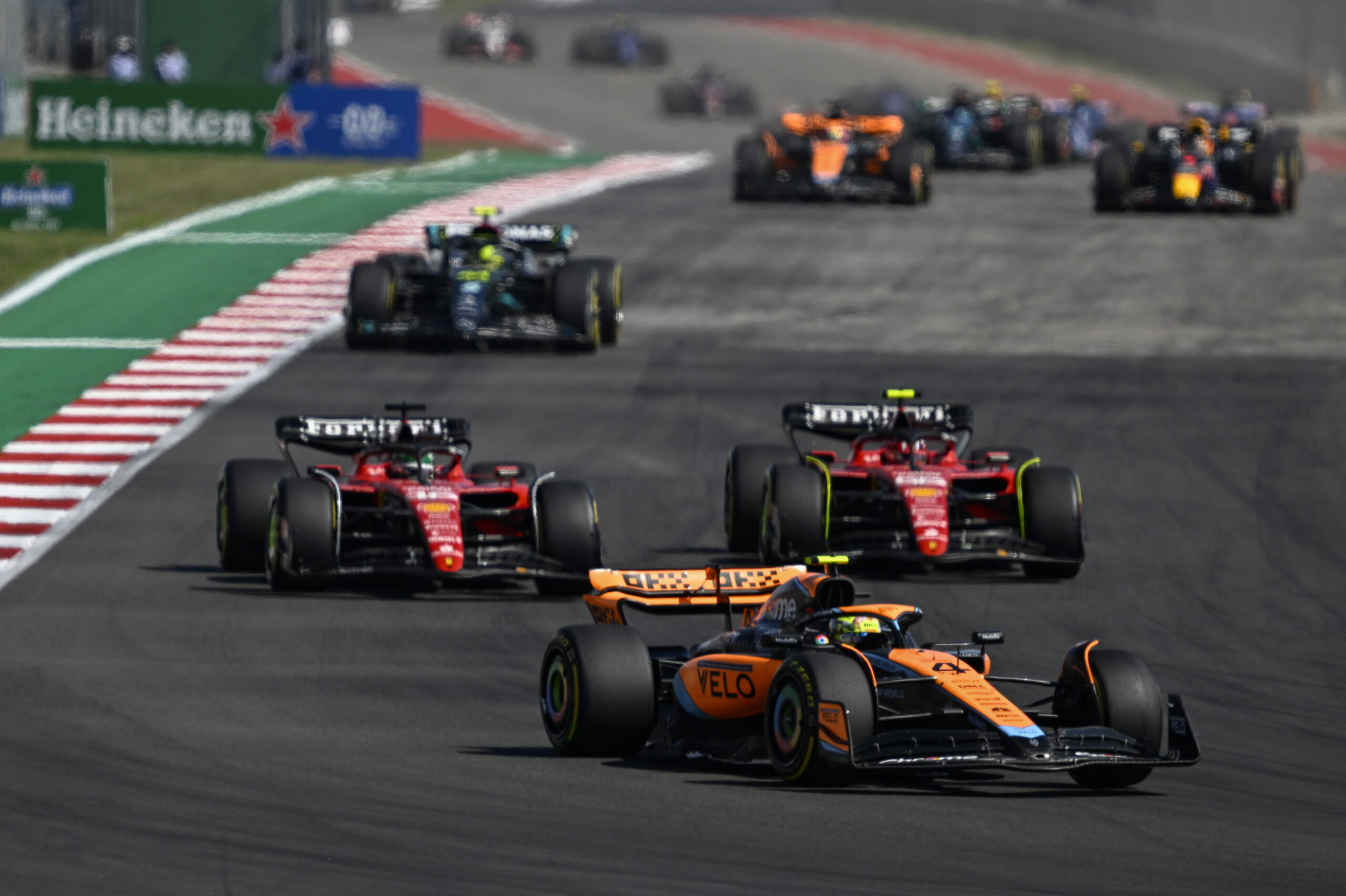 TEXAS, UNITED STATES - OCTOBER 22: Lando Norris of McLaren F1 team (4) and Charles Leclerc of Ferrari F1 team (16) compete at the F1 American Grand Prix at the Circuit of The Americas in Austin, Texas, United States on 22 October 2023. (Photo by Celal Gunes/Anadolu via Getty Images)