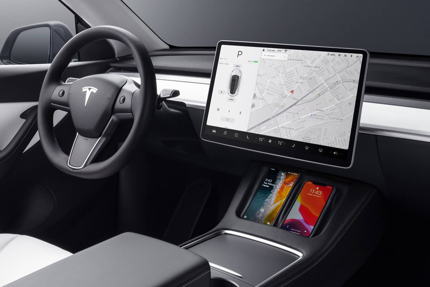 Tesla Model Y cockpit as shipped from the factory, with phones charging in their docks