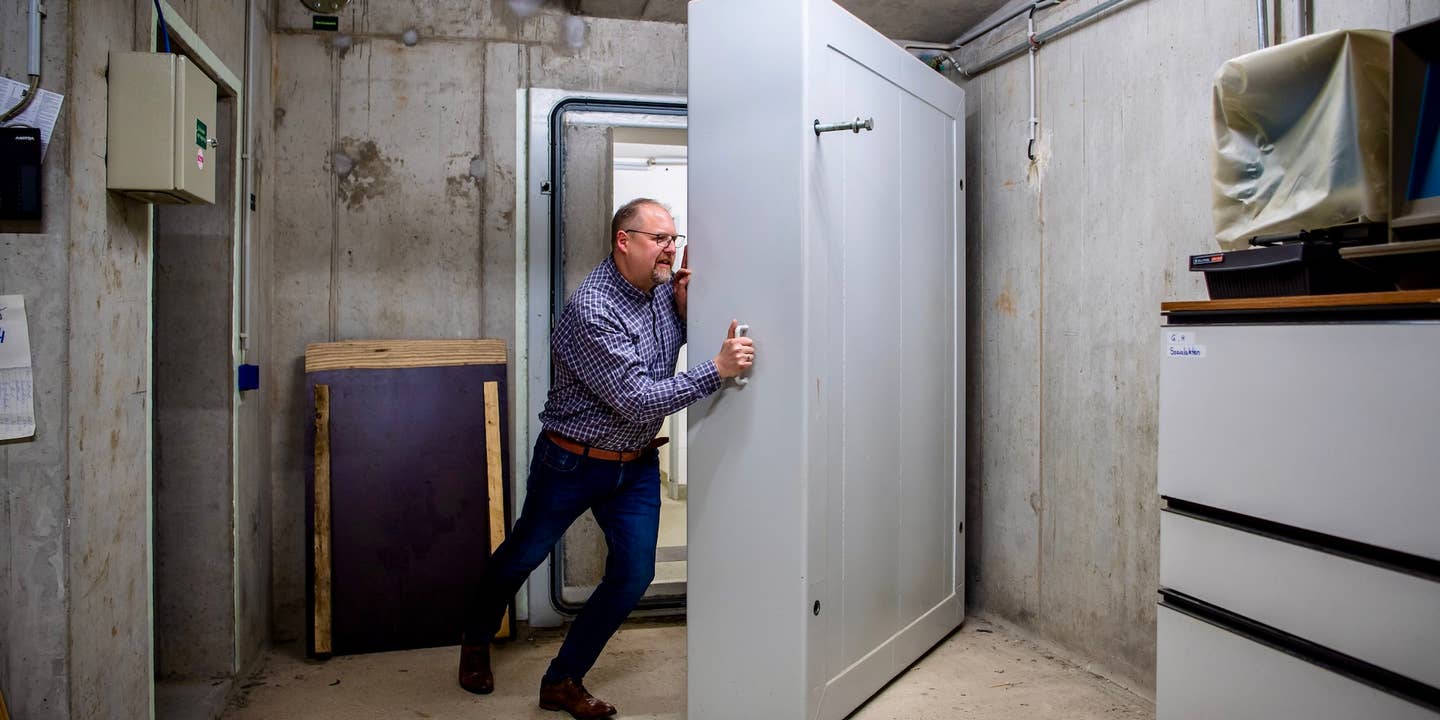 Thomas Otto (non-party), mayor of the municipality of Saterland, pries open a heavy door to the deconsecrated shelters in the basement of the town hall