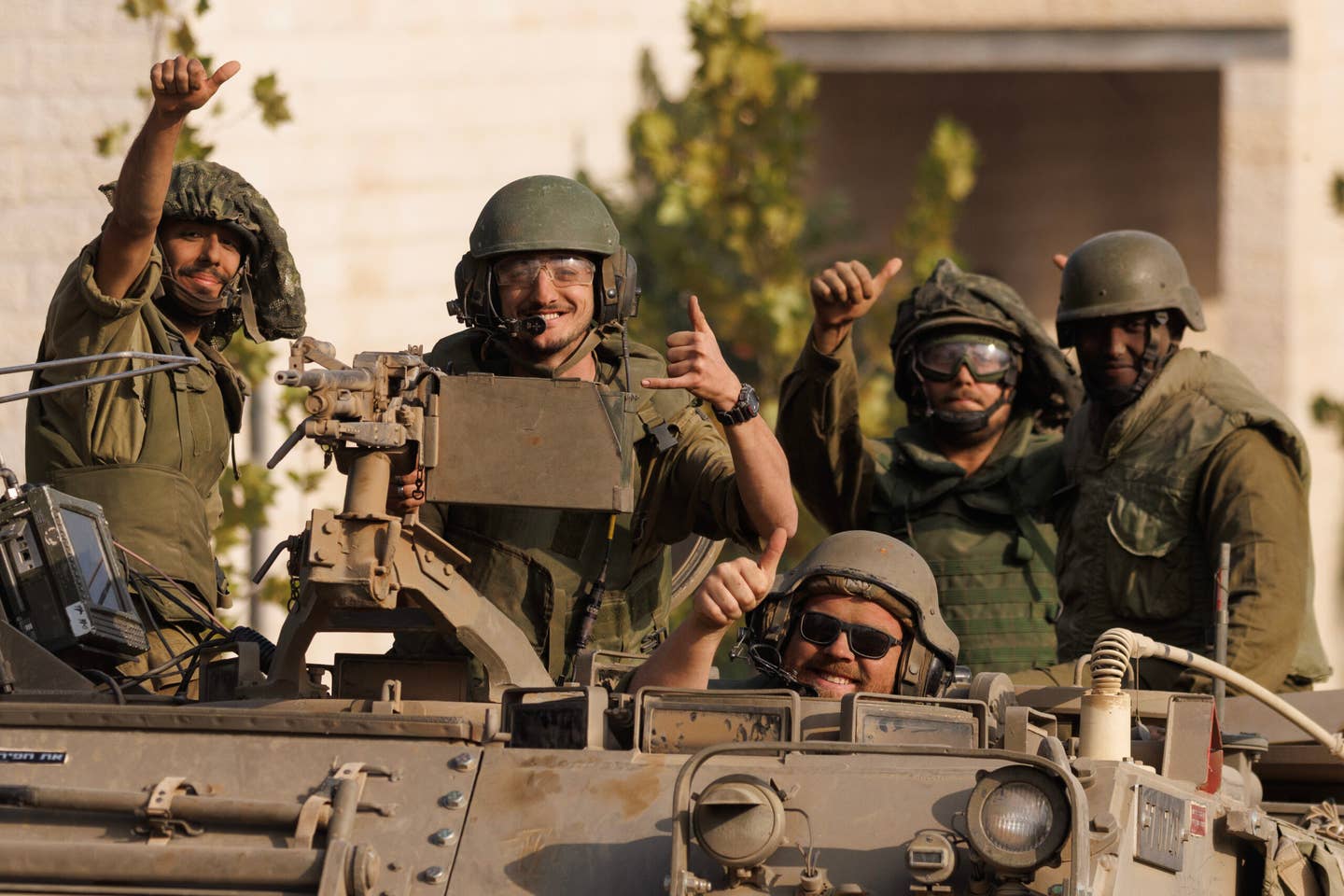 Israeli soldiers give a thumbs-up gesture as Israeli troops move near the border with Gaza on October 28, 2023, in Sderot, Israel. <em>Photo by Dan Kitwood/Getty Images</em>