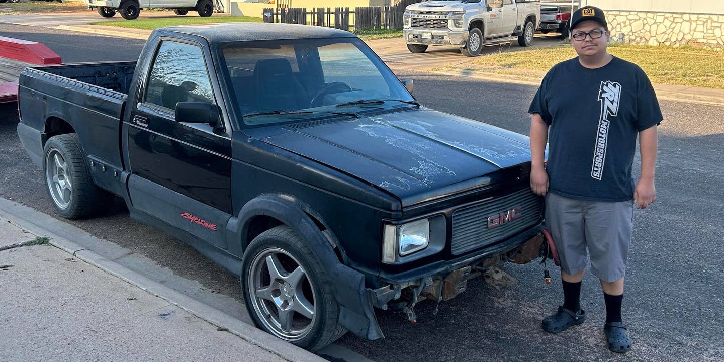 A GMC Syclone with its owner standing next to it