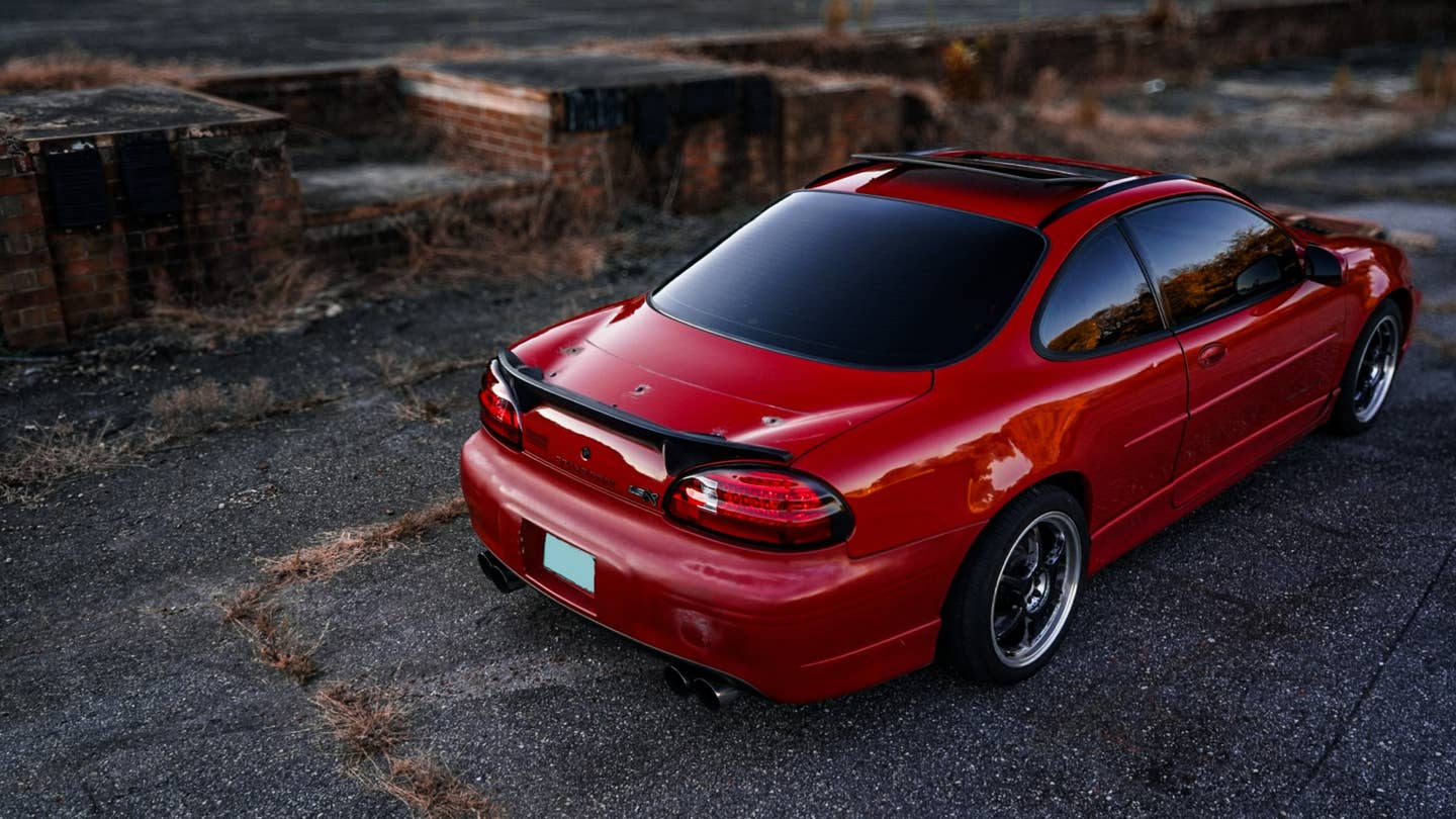 Tyler Pitman's rear-wheel-drive, V8-swapped 1999 Pontiac Grand Prix, viewed from the rear three-quarter view. The car is red.