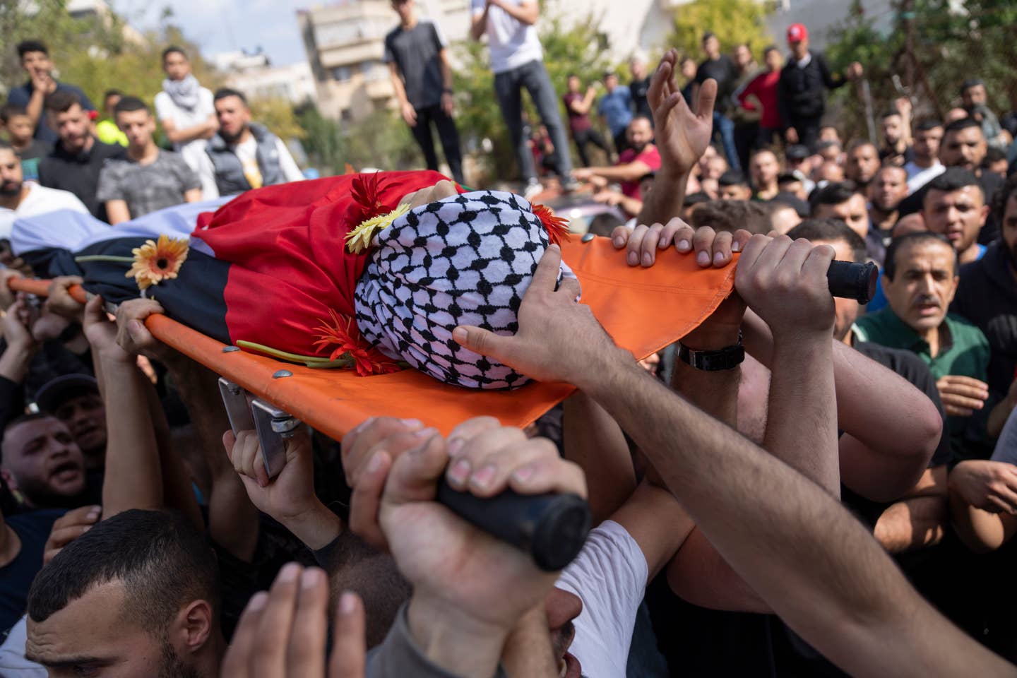 Truchlící nesou tělo Ayhama Shafe'e, 14, během jeho pohřbu ve městě Ramalláh na Západním břehu ve čtvrtek 2. listopadu 2023. Shafee a druhý Palestinec byli zabiti během náletu izraelské armády v Ramalláhu časně ráno. Informovalo o tom palestinské ministerstvo zdravotnictví. (AP Photo/Nasser Nasser)