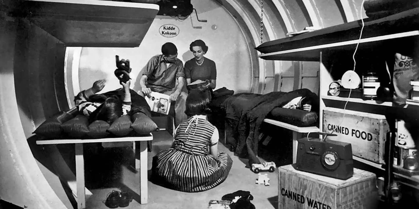 A family rests in their at-home nuclear fallout shelter