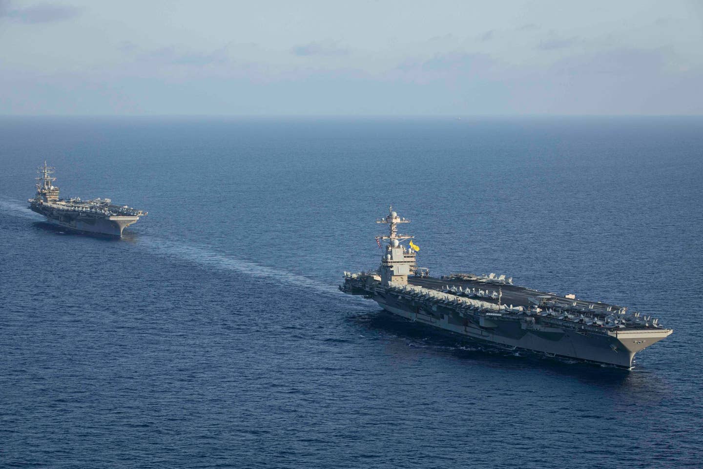 The world’s largest aircraft carrier<em> USS Gerald R. Ford</em> (CVN 78) steams in formation with the <em>Nimitz</em>-class aircraft carrier <em>USS Dwight D. Eisenhower</em> (CVN 69) during a photo exercise, Nov. 3, 2023.  (U.S. Navy photo by Mass Communication Specialist 2nd Class Malachi Lakey)
