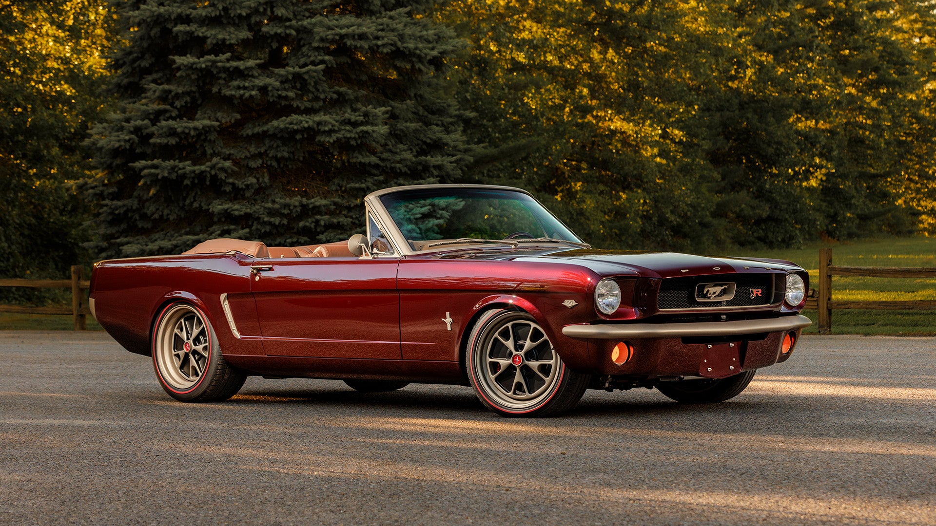 The 1965 Ford Mustang by Ringbrothers is a sleek and powerful cruiser, boasting an understated perfection with its coyote-powered engine.