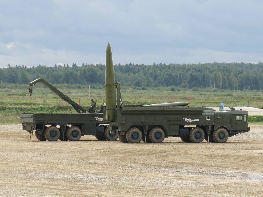 Two parts of the Iskander (SS-26 Stone) short-range ballistic missile system: a 9P78-1 launcher for the 9K720 missiles in the foreground and a 9T250 transloader vehicle in the background. <em>Boevaya mashina/Wikimedia Commons</em>
