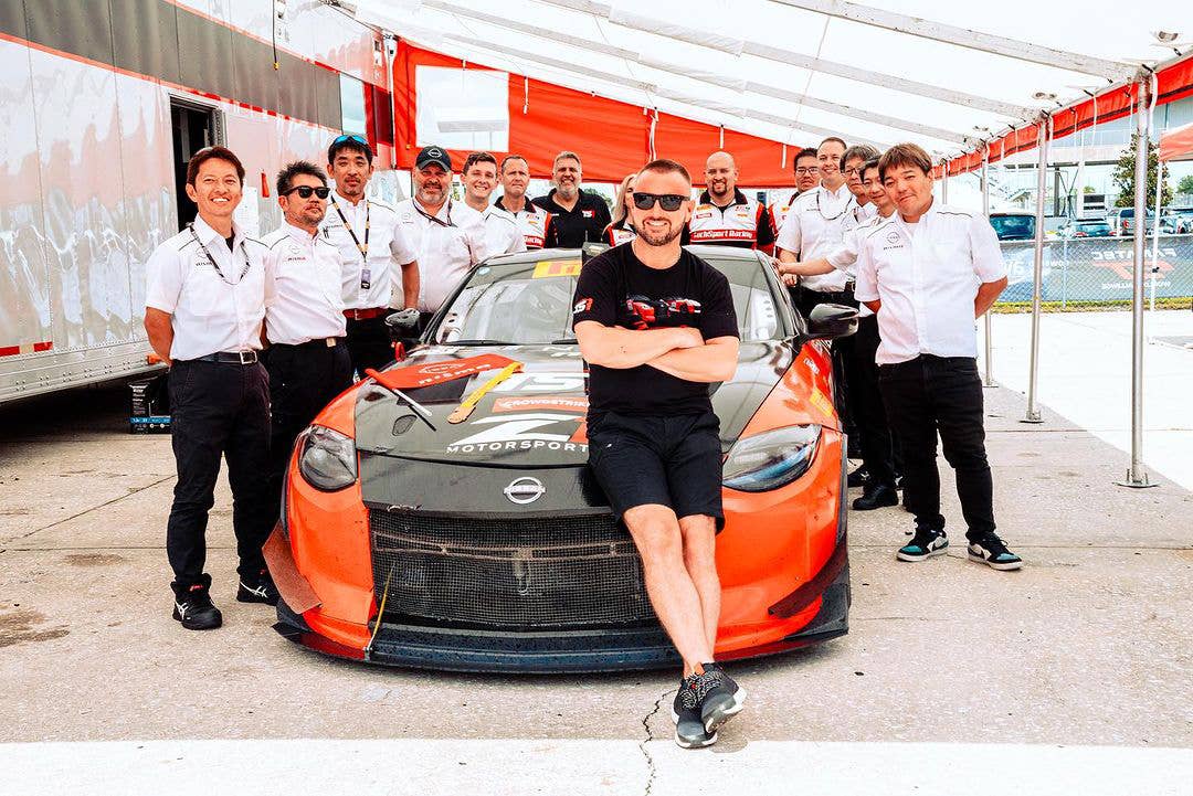 Eric Powell posing with his TechSport team and Nissan Z during the 2023 GT4 America season.