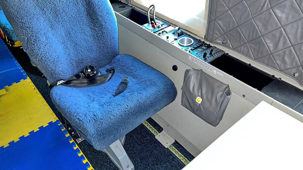 One of the seats on the right side of the NC-20G's main cabin, with a set of controls alongside it. <em>USAF</em>