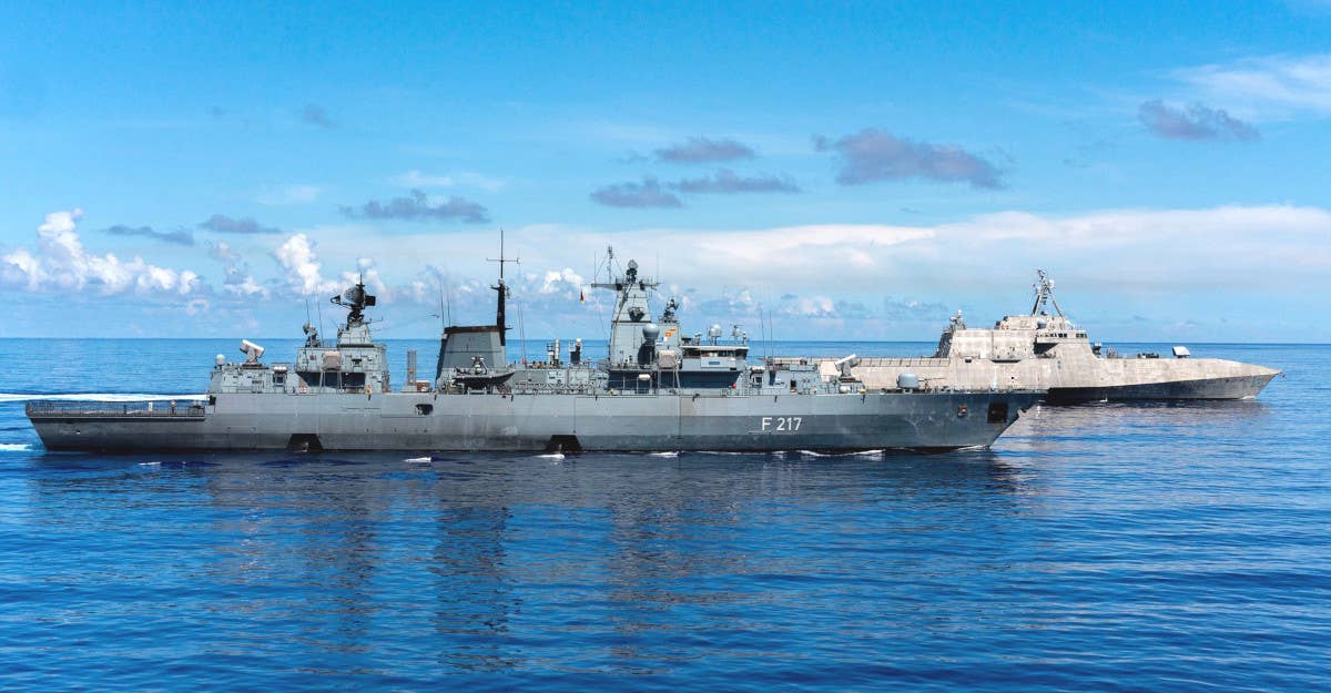 The German Navy's <em>Brandenburg</em> class frigate <em>Bayern</em> sails alongside the US Navy's <em>Independence</em> class Littoral Combat Ship (LCS) USS <em>Jackson</em> in the Philippine Sea in 2021. <em>USN</em>