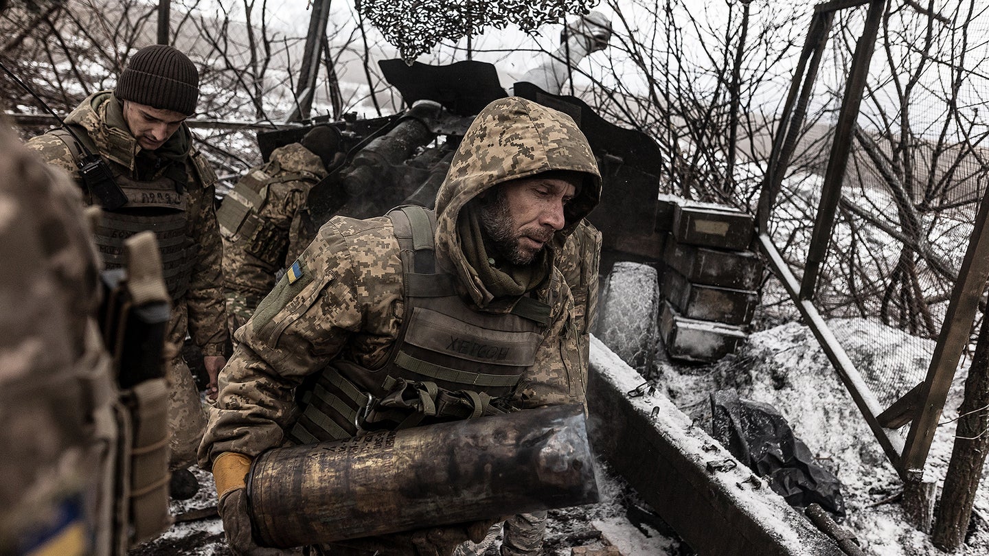 Ukrainian soldiers of the 57th Brigade collect the remains of a powder charge from D-20 artillery at their fighting position, in the direction of Kupiansk, in Kharkiv, Ukraine on November 27, 2023.