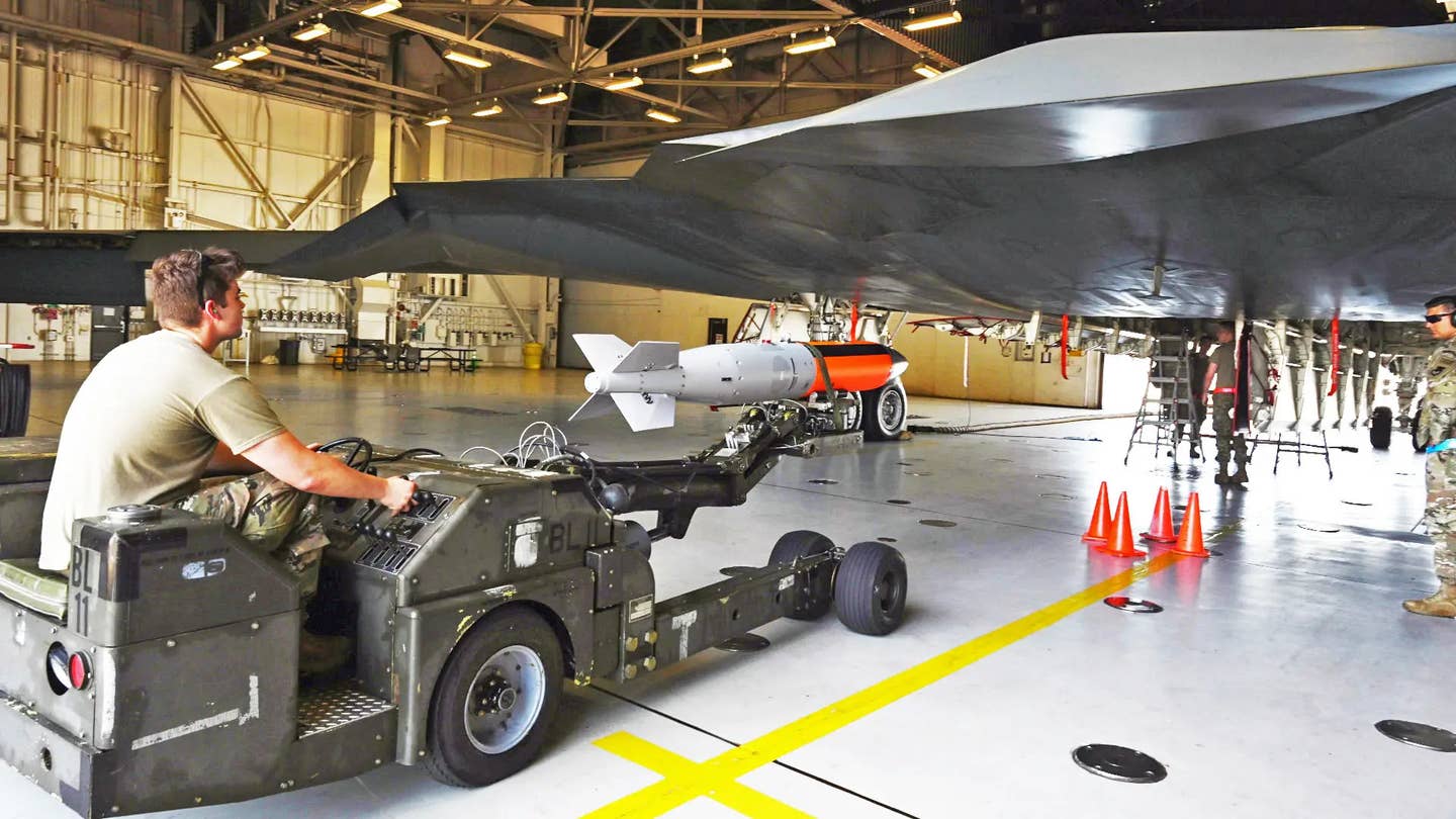 Air Force personnel load a test version of the B61-12 onto a B-2 bomber. <em>USAF</em>