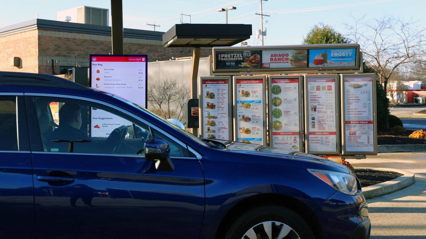 Wendy's customer uses the "FreshAI" ordering system in a drive-thru