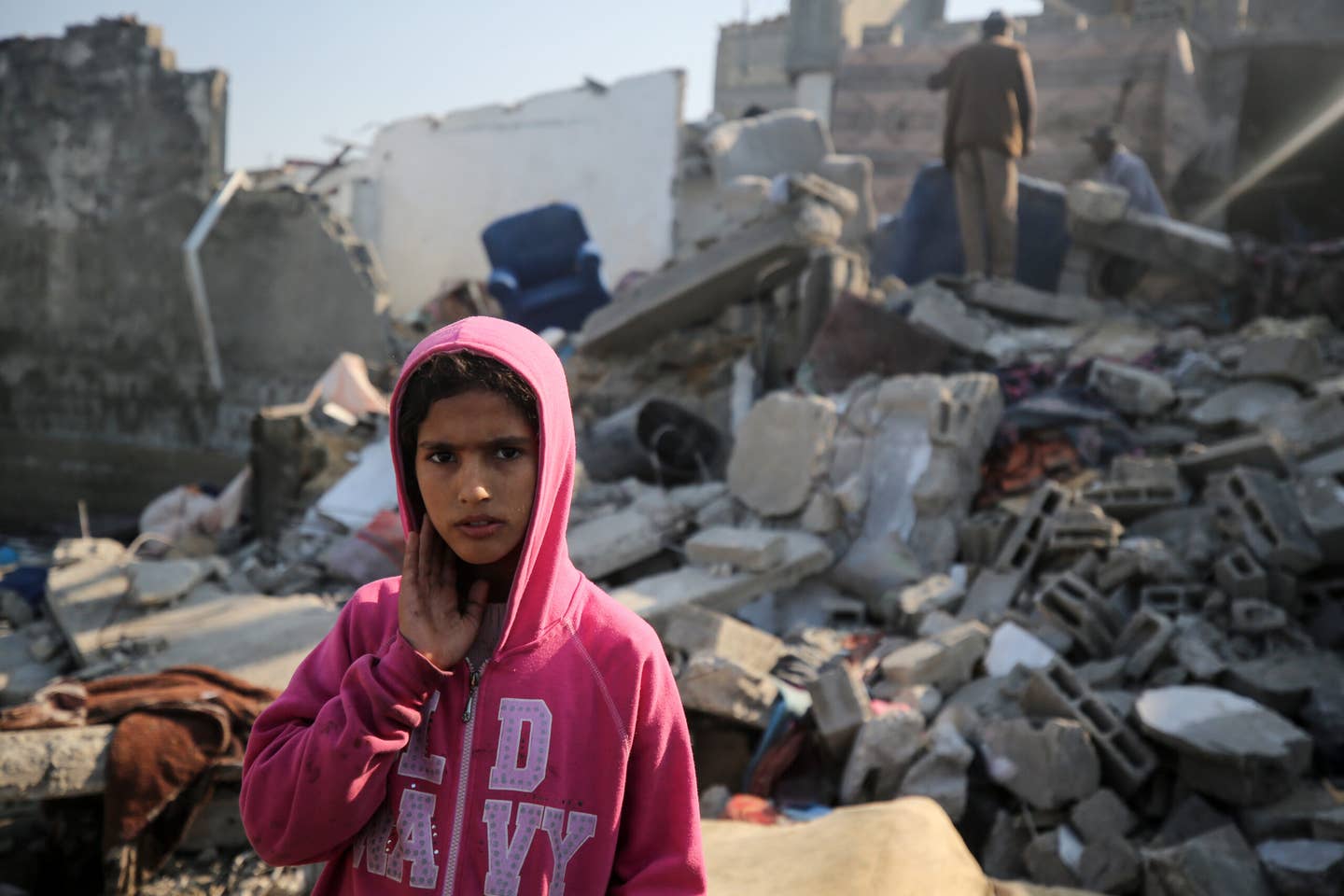Palestinians are gathering amid the rubble of destroyed buildings following an Israeli bombardment in Deir El-Balah, in the central Gaza Strip, on December 19, 2023, as battles between Israel and the Palestinian militant group Hamas continue. (Photo by Majdi Fathi/NurPhoto via Getty Images)