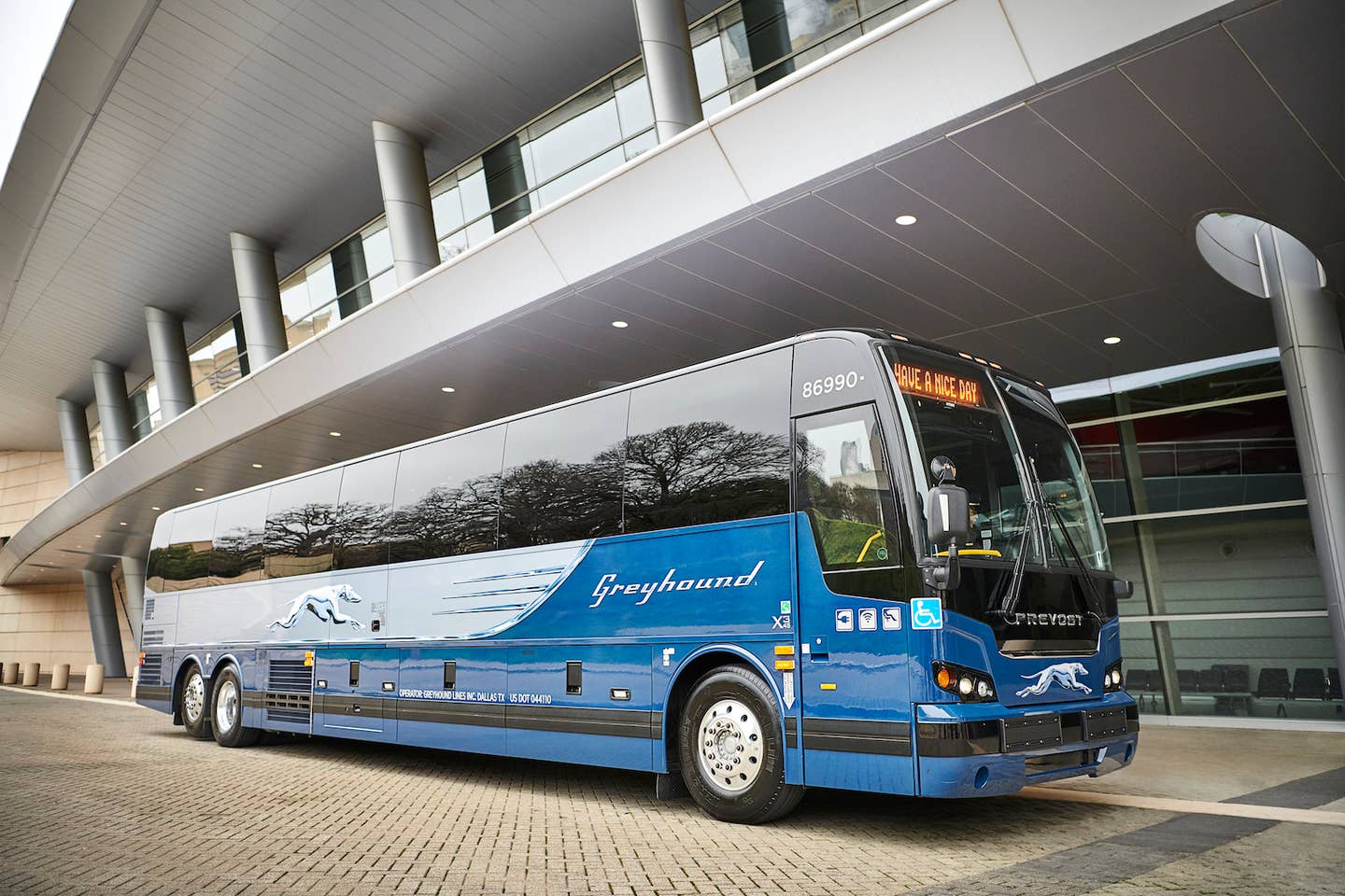 A Greyhound coach bus at a modern terminal