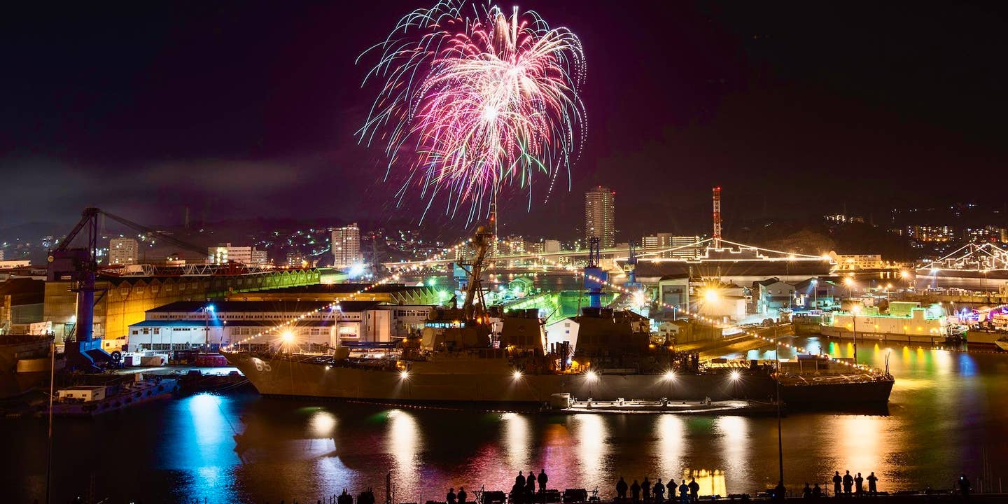 Sailors observe fireworks behind the Arleigh Burke class destroyer USS Benfold on New Year's Eve 2015, Yokosuka, Japan.