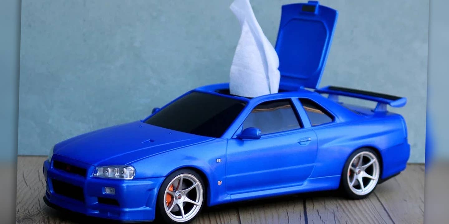 A blue Nissan Skyline GT-R model (R34) with a hatch in its roof to dispense tissues