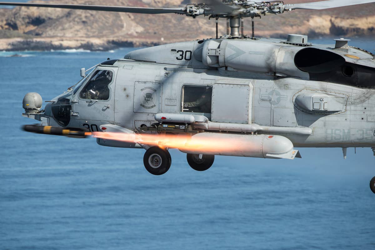 An MH-60R Sea Hawk helicopter, assigned to Helicopter Maritime Strike Squadron (HSM) 35, fires an AGM-114M Hellfire missile near San Clemente Island, Calif., during a live-fire combat training exercise. (U.S. Navy Combat Camera photo by Mass Communication Specialist 2nd Class Arthurgwain L. Marquez/Released)