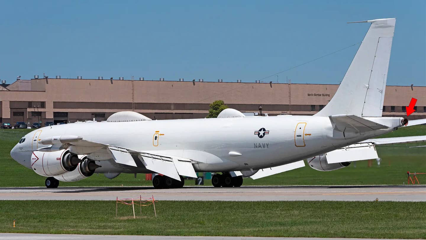 A picture of an E-6B with a red arrow pointing to the tip of the five-mile-long antenna the aircraft can unspool to communicate with submerged <em>Ohio</em> class nuclear ballistic missile submarines. <em>USAF</em>