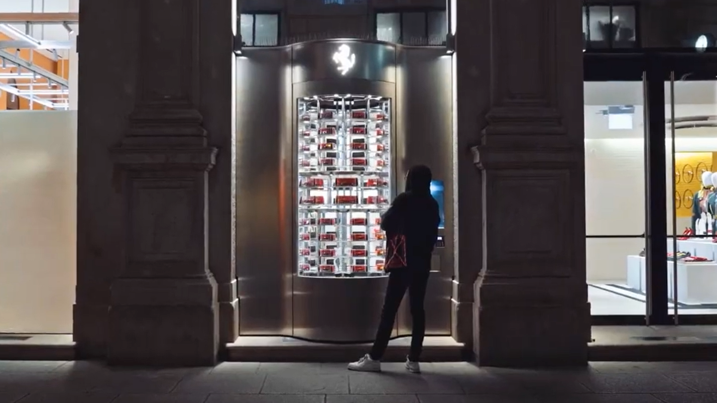 silhouette of a person in front of ferrari vending machine