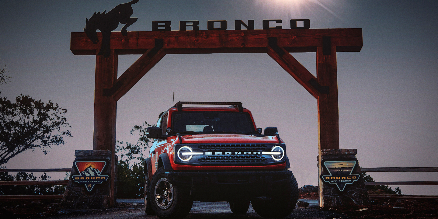 Ford Bronco SUV in front of Bronco sign
