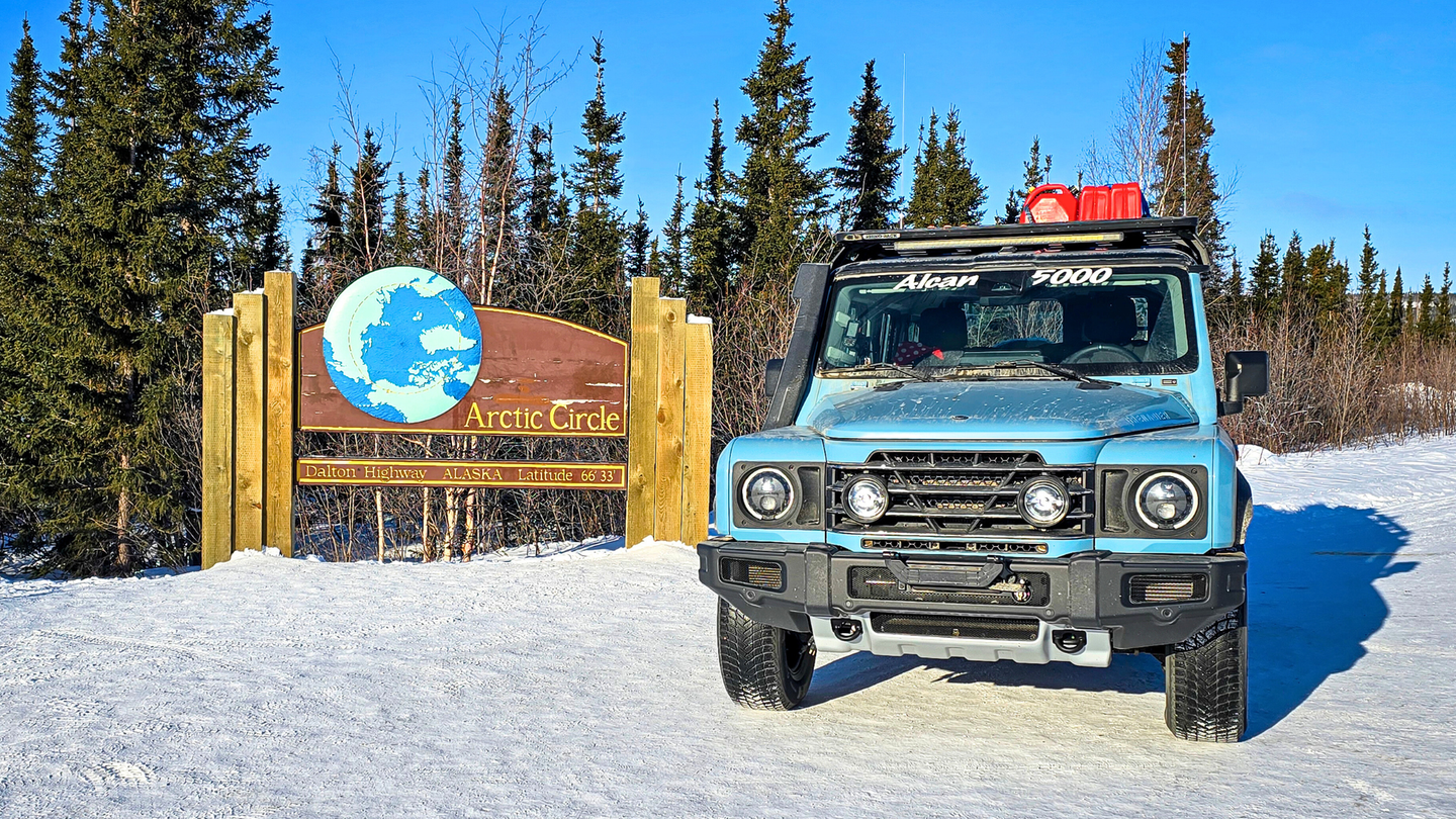blue suv by Arctic Circle sign