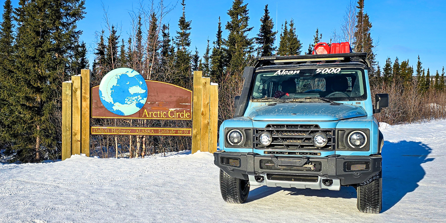 blue suv by Arctic Circle sign