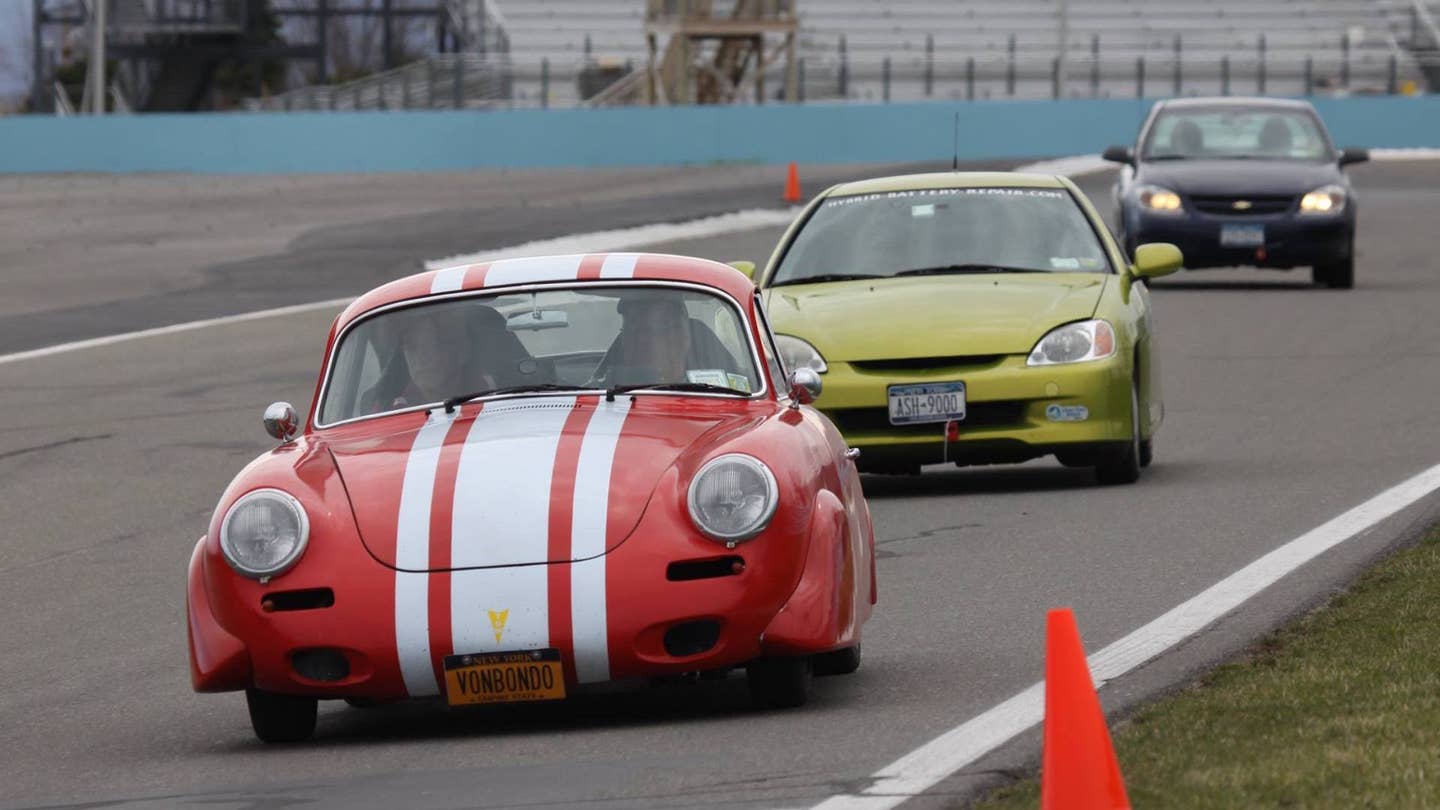 A classic Porsche tailed by a Honda Insight at the Toyota Green Grand Prix