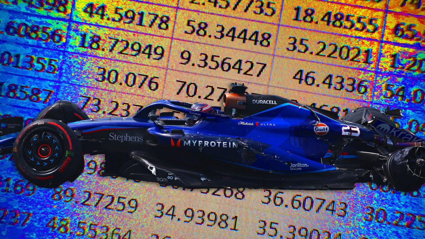 A crashed Williams Formula 1 car in front of a backdrop of a Microsoft Excel spreadsheet