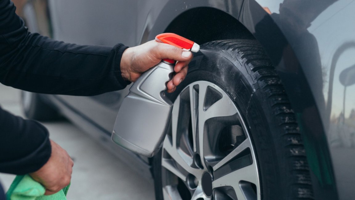 Close up man cleaning car tires